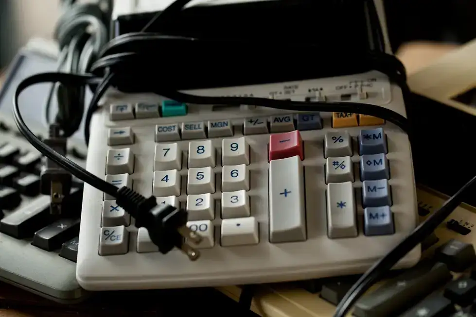 Old desk calculators tangled in their power cords