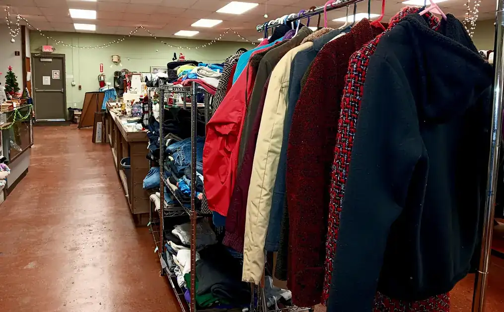 An aisle of coats and clothing racks in the resale store